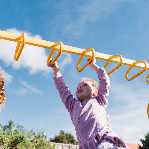 Children playing outdoors at Busy Bees Early Education Centre