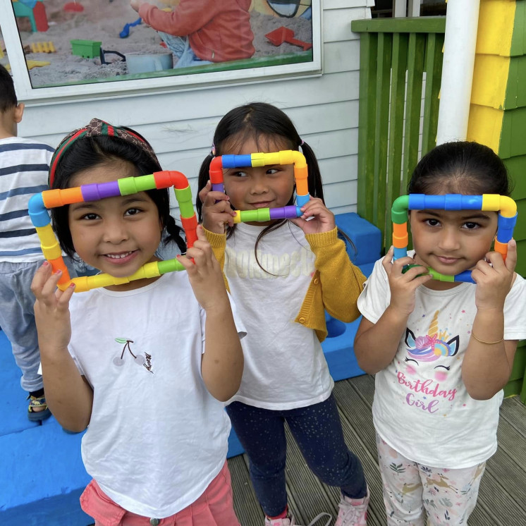 Preschool friends showing off their creations at Busy Bees Alfriston Road
