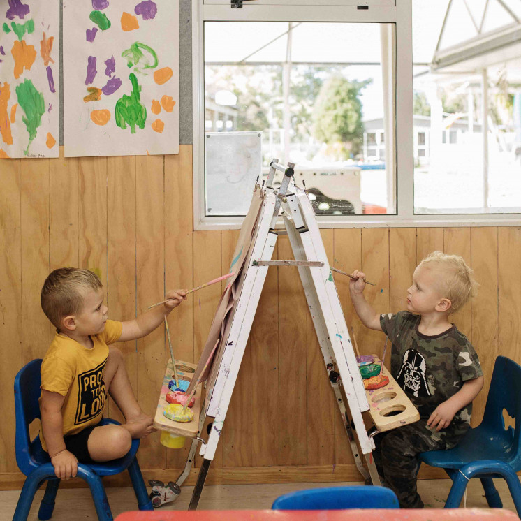 Busy Bees Cambridge childcare artistic development with creative painting activity 