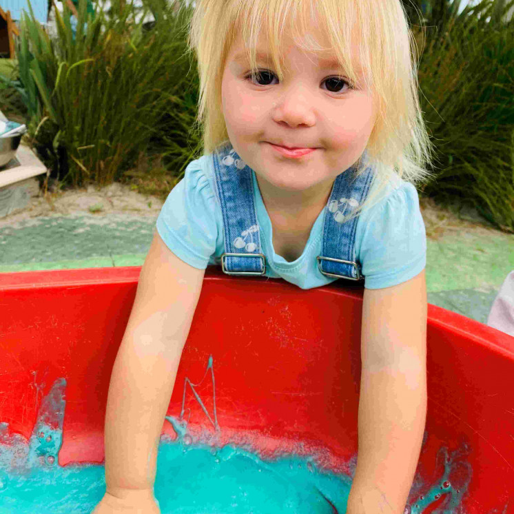 Child at Busy Bees Coopers Beach doing sensory play