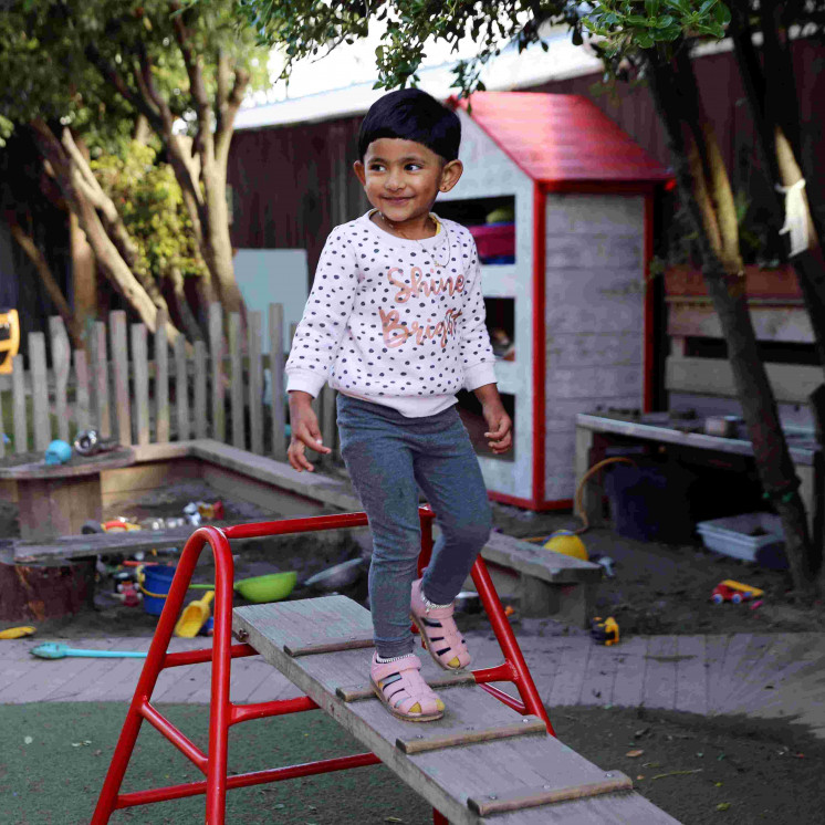 Preschooler mastering balancing outside at Busy Bees Hastings