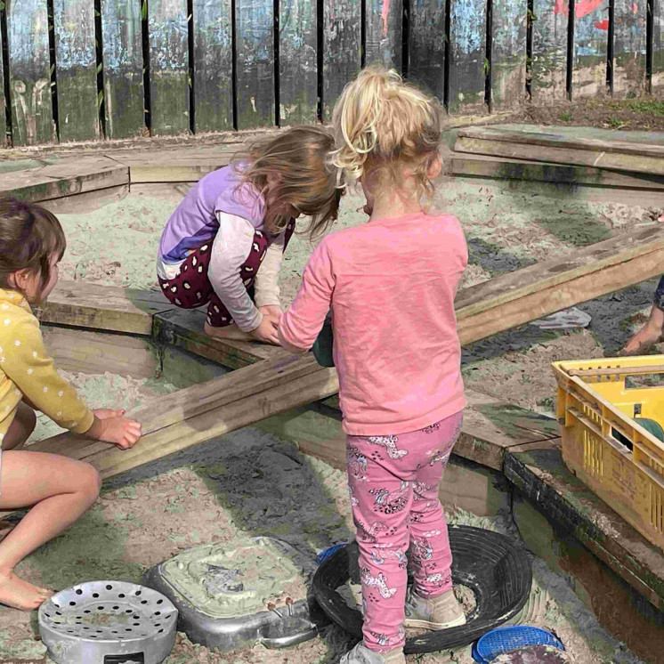 Preschoolers playing in large outdoor sandpit at Busy Bees Kerikeri Preschool