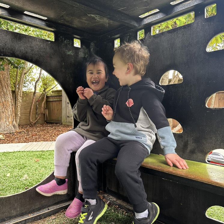 Two friends laughing at Busy Bees Motueka