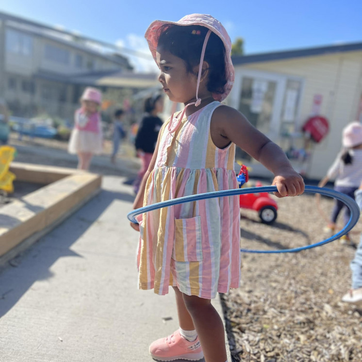3 Year old girl mastering the hula hoop at Busy Bees Mount Wellington