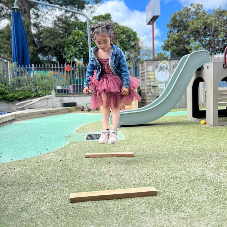 Busy Bees Pakuranga outdoor play jumping around