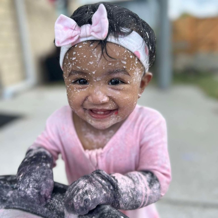 Smiley baby messy sensory play at Busy Bees Papamoa Beach