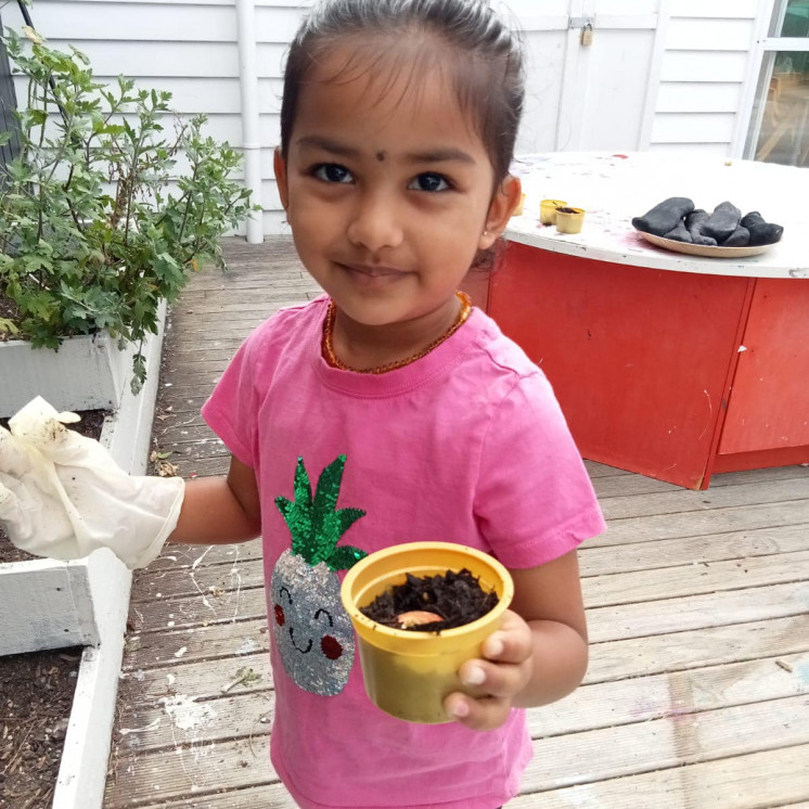 Kindergarten children busy themselves helping grow veges in our raised garden beds at Busy Bees Roscommon Road