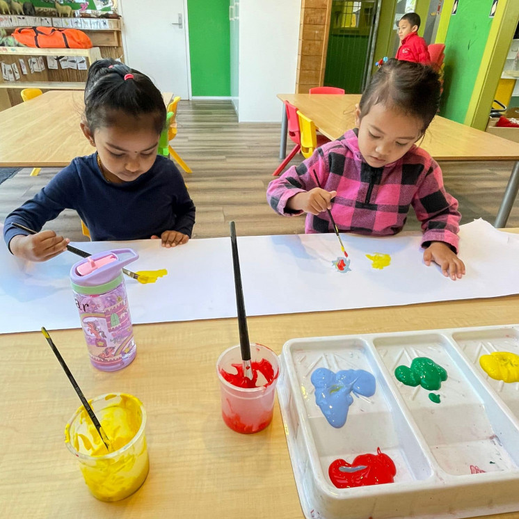 Two friends enjoying focused time painting at Busy Bees Roscommon Road
