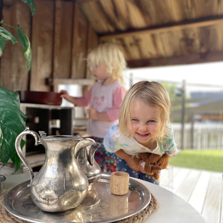 Girls tea party pretend play having fun outdoors childcare