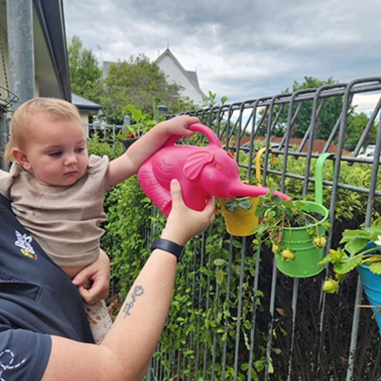 Baby watering the plants at Busy Bees Southbrook 