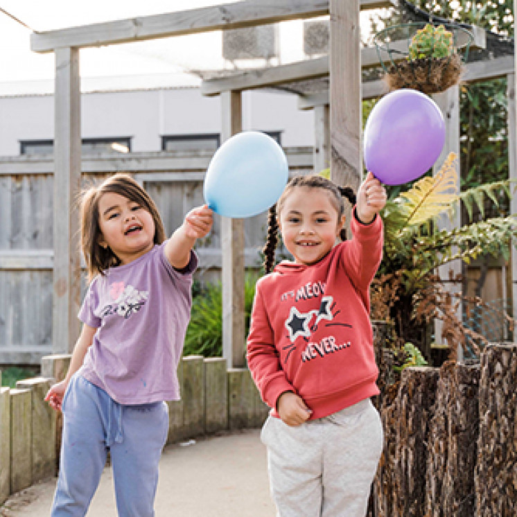 Girls outside playing with ballons at Busy Bees Terrace End