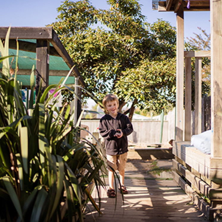 Little boy exploring outside at Busy Bees Western Heights 