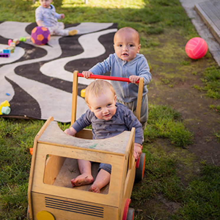 Babys pushing each other on trolley at Busy Bees Western Heights