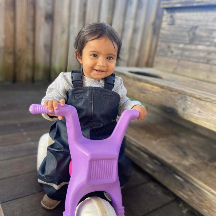 Busy Bees Westgate baby riding bike outside 