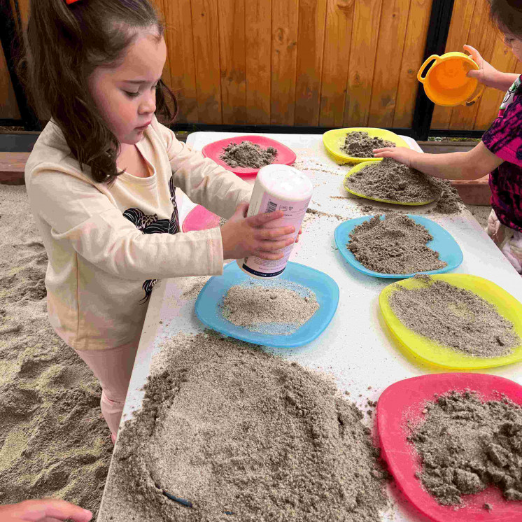 Toddler girls in sandpit at Busy Bees whakatau