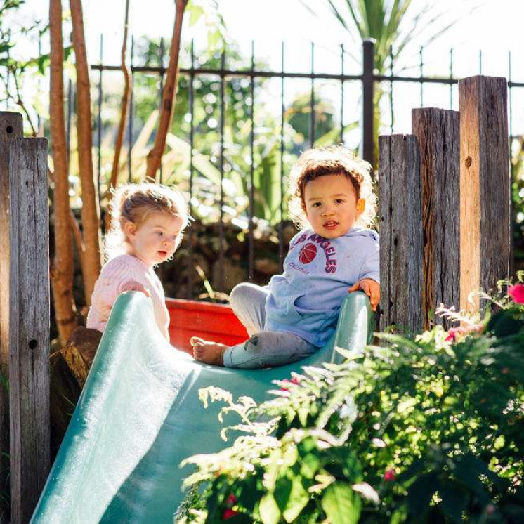 Infants playing on the slide at Busy Bees Whau Valley 