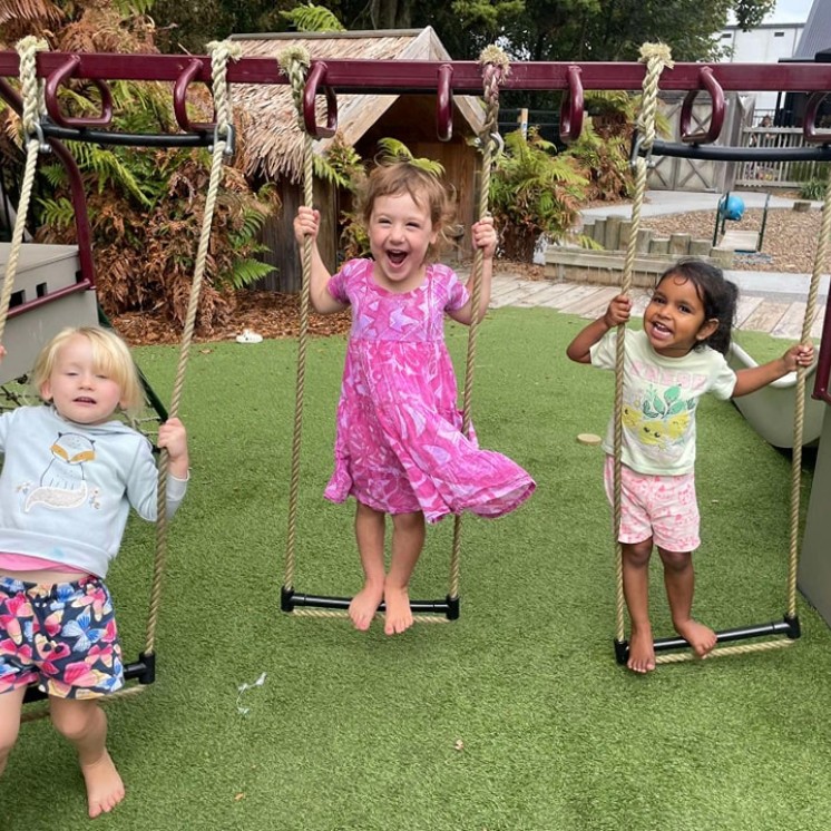 House of Wonder Cambridge childcare girls playing on swing