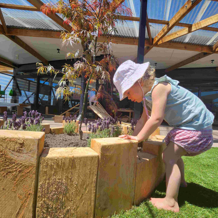 Girl tending to garden at Busy Bees Tairāwhiti childcare in Gisborne