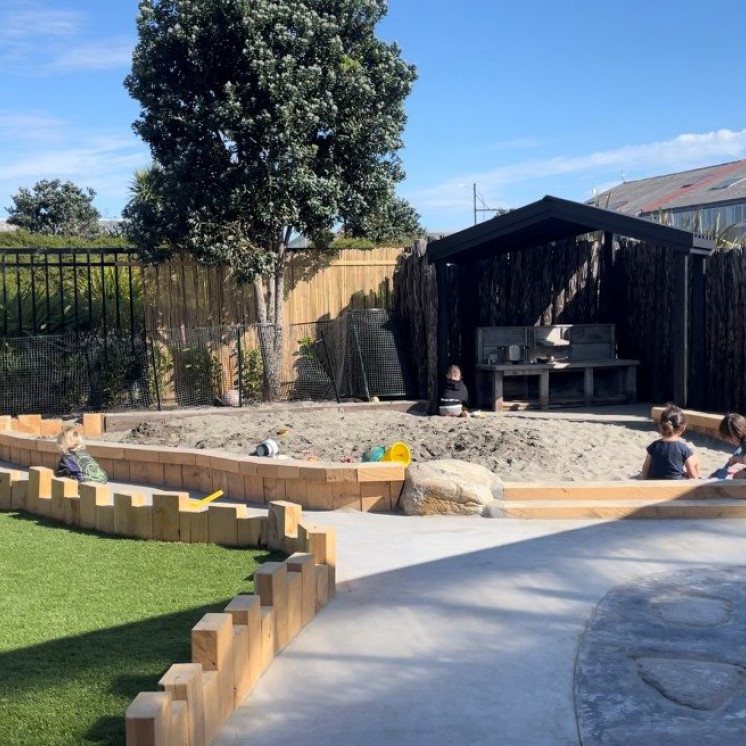 Busy Bees Tairāwhiti childcare in Gisborne New Playground and two children enjoying the sandpit