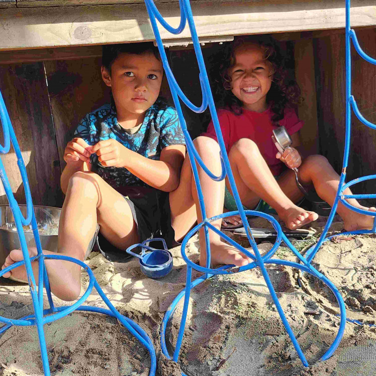 Two boys in the sandpit at Busy Bees Tairāwhiti childcare in Gisborne